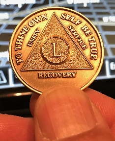 Lucki's 50th Anniversary Coin held by her son Rey